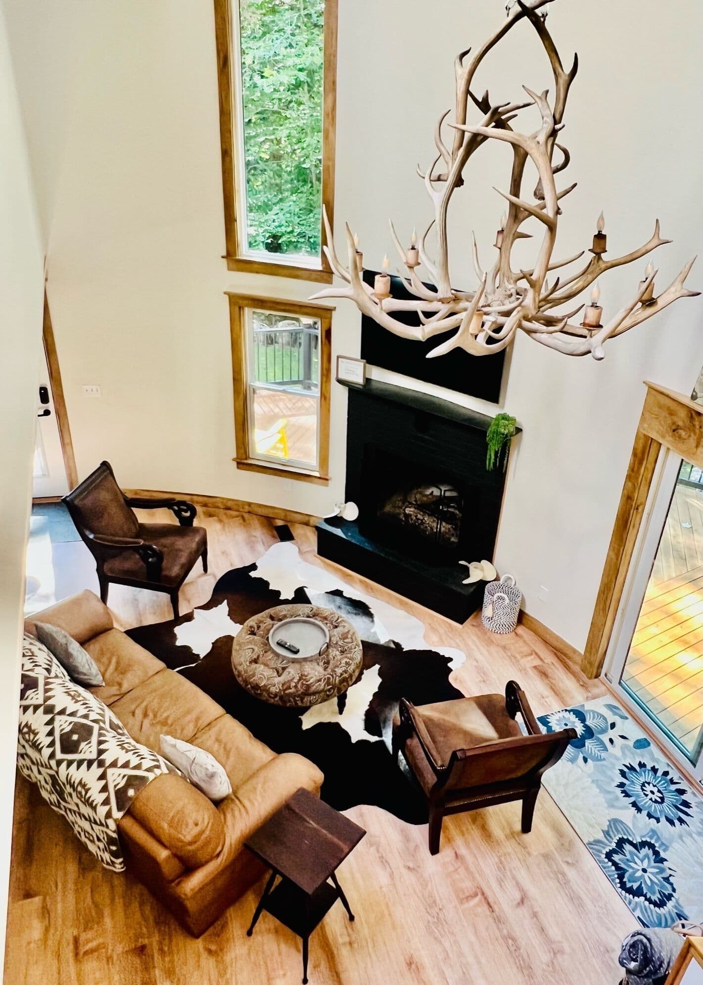 Living room with fireplace and antler chandelier